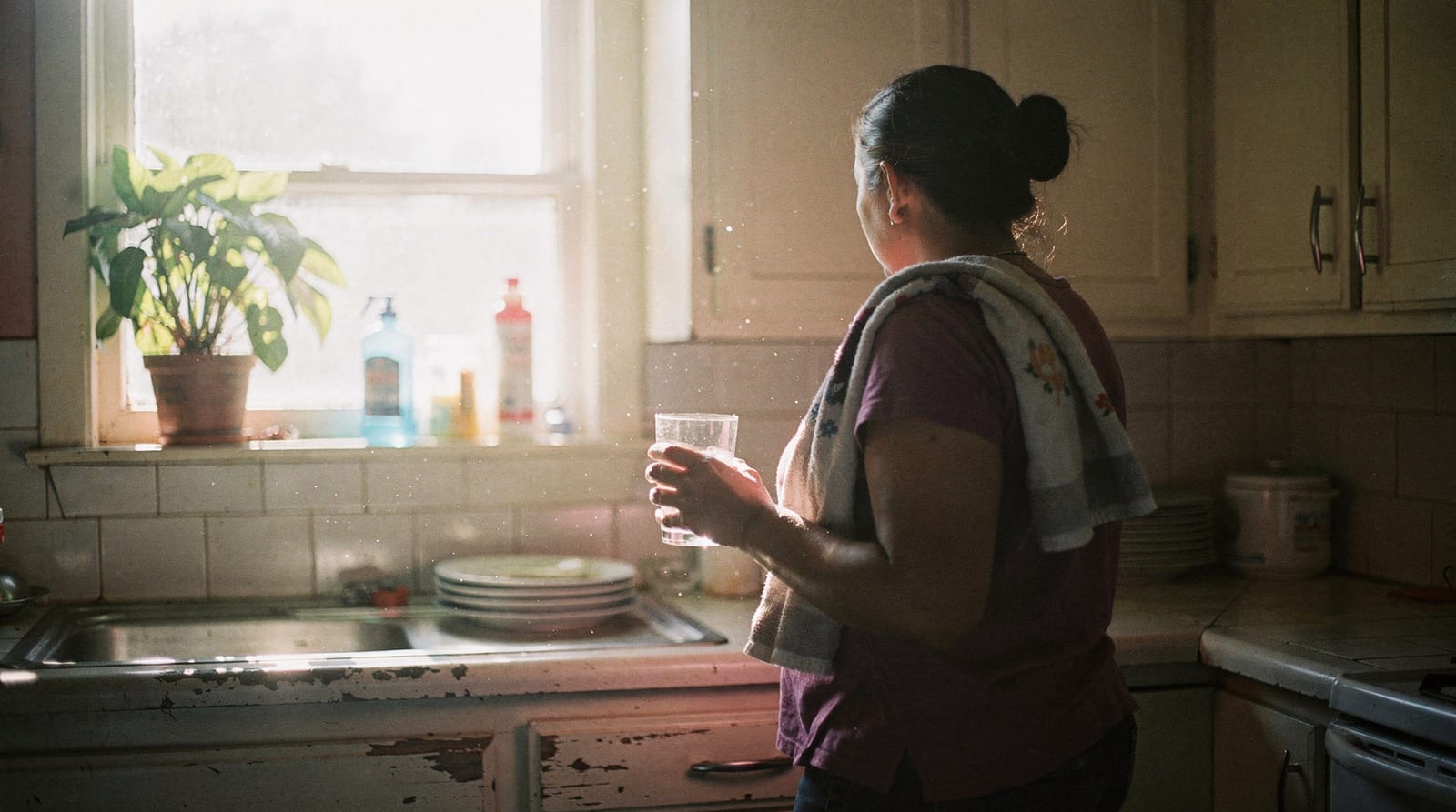A domestic worker at home in Thailand, photographed with dignity and without an identifiable face.